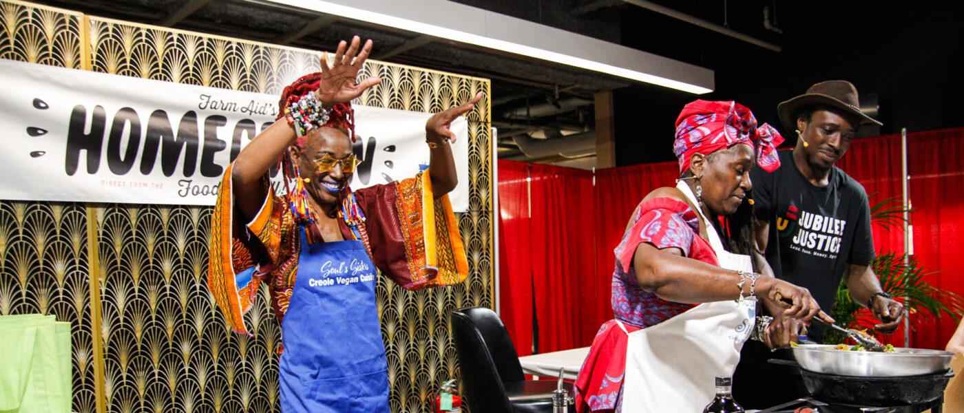 three people on-stage for a cooking demonstration